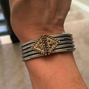 Heavy metal hinged bracelet in silver/ gold tones.